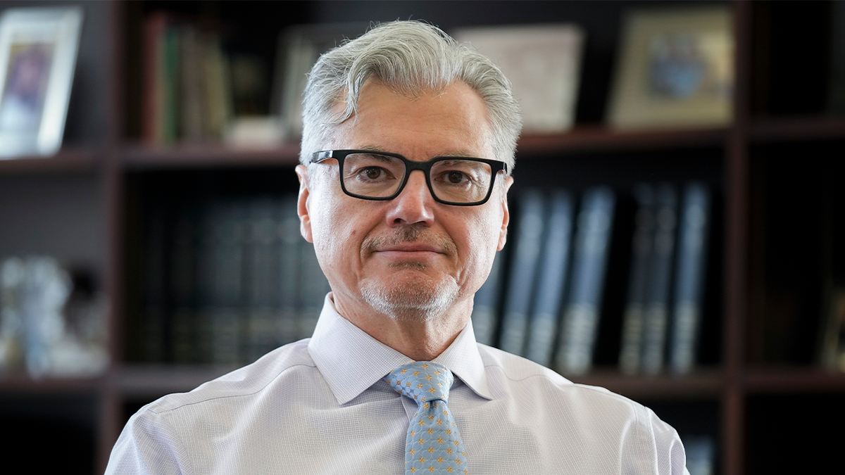 Judge Merchan in white shirt, blue tie in chambers