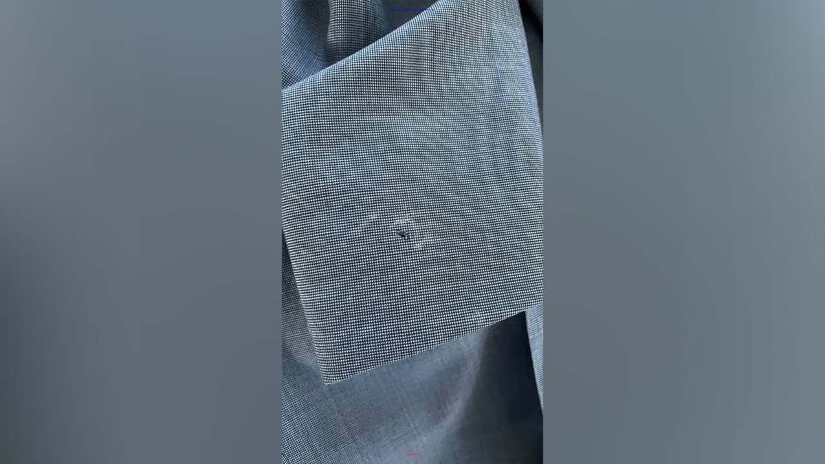 Bite marks by Commander Biden in suit jacket