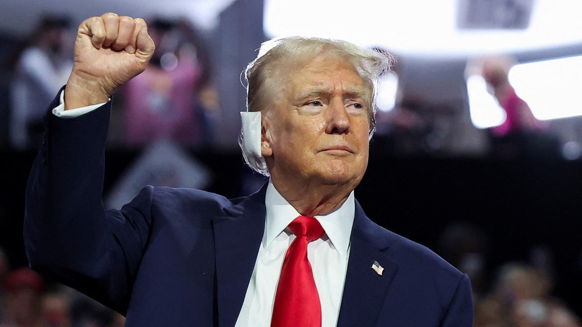 Donald Trump raises his fist during Day 1 of the Republican National Convention