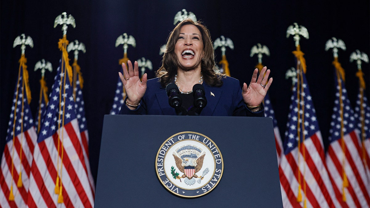 Kamala Harris laughing at podium in Milwaukee