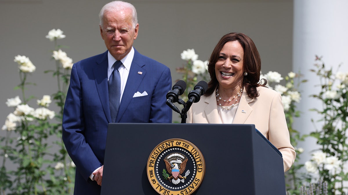 Kamala Harris speaks while Joe Biden looks on