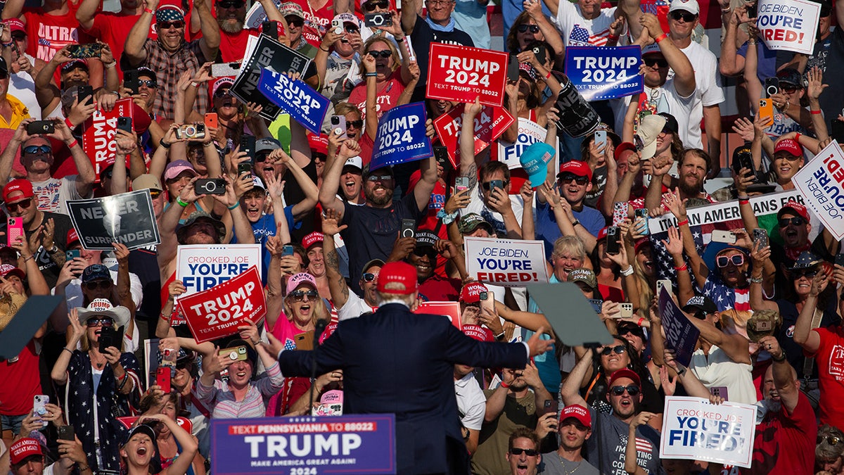 Donald Trump greets the crowd during a campaign event at Butler Farm Show Inc