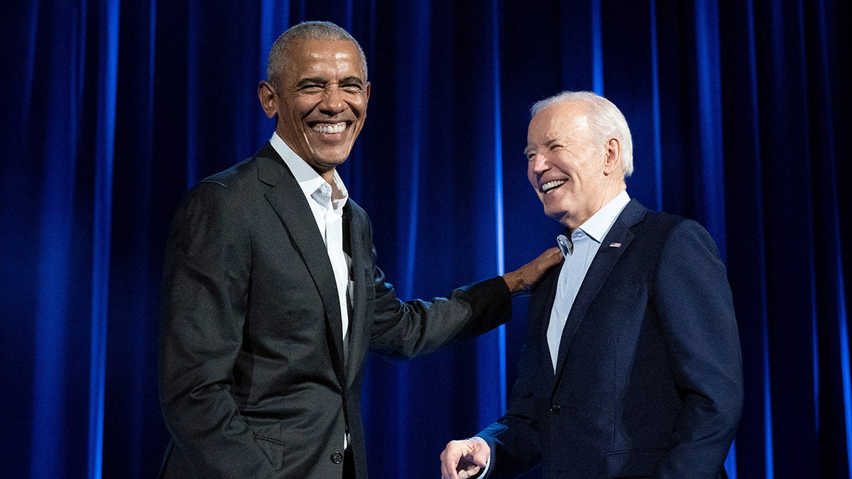 Barack Obama laughing with Joe Biden in March 2024