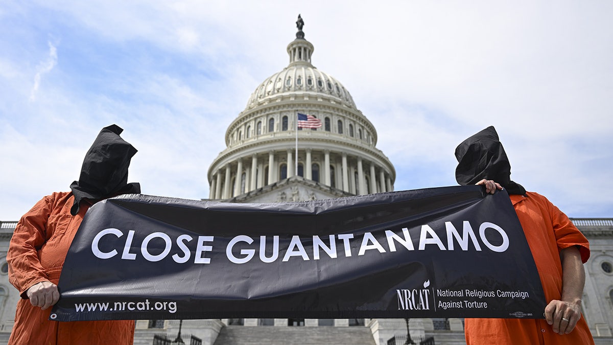 DC protesters hold sign in front of Capitol calling for closure of Guantanamo Bay