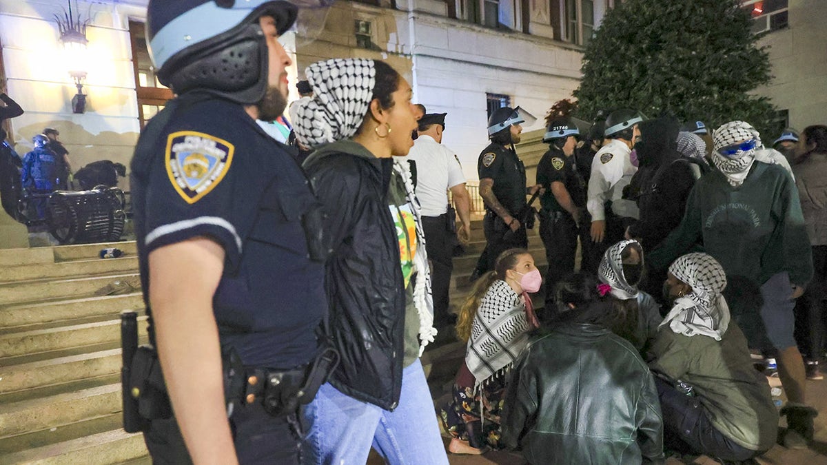 Arrested demonstrator escorted out of Hamilton Hall by NYPD