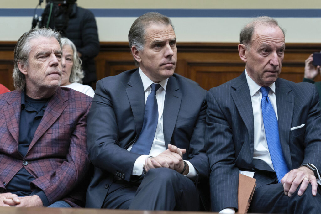 Hunter Biden, President Joe Biden's son, center, accompanied by his attorney Abbe Lowell, right, sit in the front row at a House Oversight Committee hearing as Republicans are taking the first step toward holding him in contempt of Congress, Wednesday, Jan. 10, 2024, on Capitol Hill in Washington. (AP Photo/Jose Luis Magana)