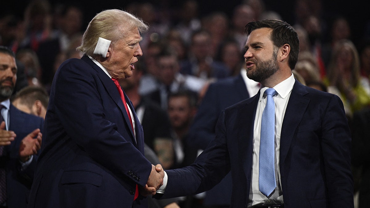 Donald Trump shakes hands with JD Vance