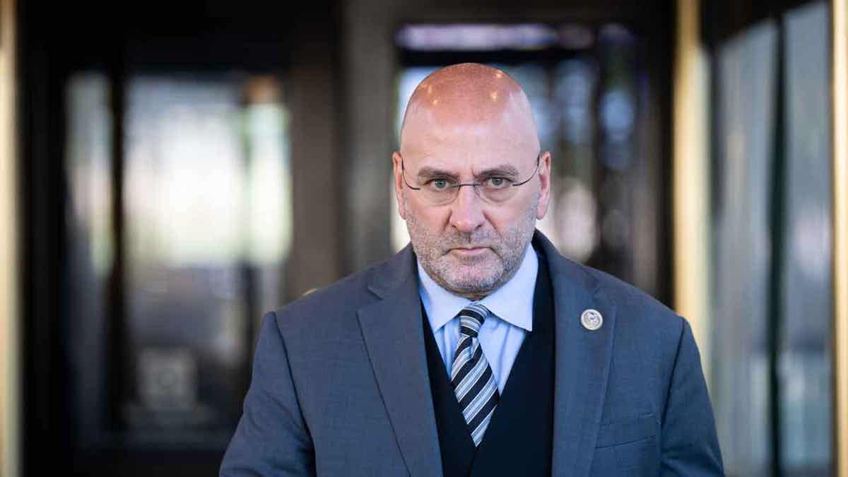 Clay Higgins walks toward a camera