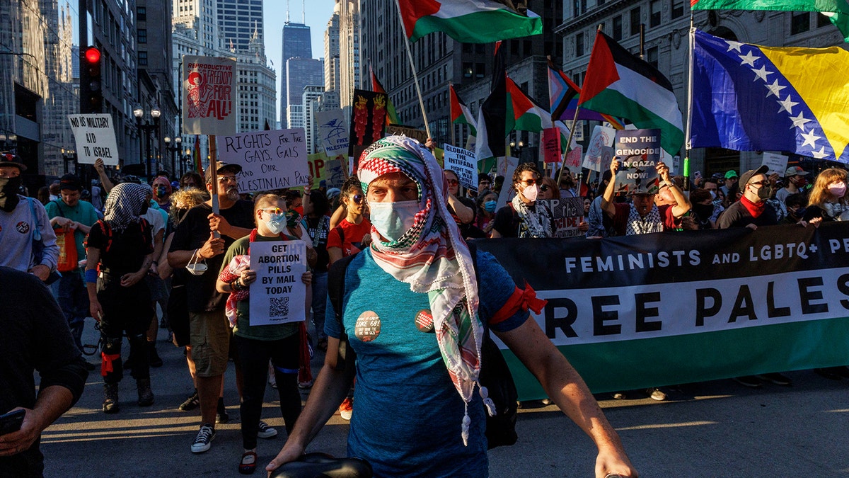 Activists march on North Michigan Avenue on Sunday, Aug. 18, 2024, in Chicago, host city for the Democratic National Convention. The protest was organized by CODEPINK, a women-led anti-war nonprofit that seeks to redirect tax dollars into health care, education and green jobs.