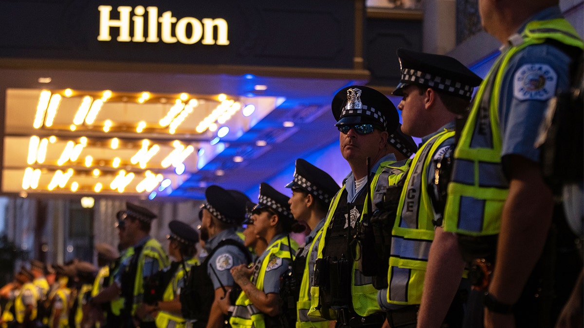 Police stand guard in front of the Hilton hotel as anti-Israel agitators march ahead of the Democratic National Convention on Aug. 18, 2024 in Chicago, Ill.