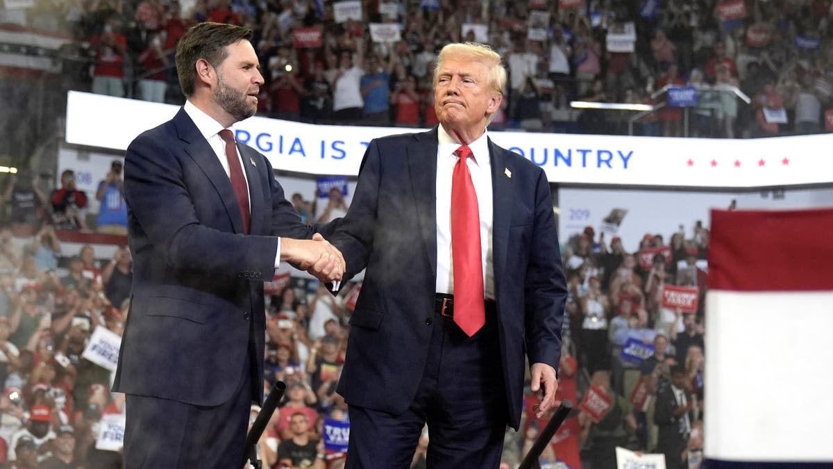 Republican vice presidential candidate Sen. JD Vance, R-Ohio, left, greets Republican presidential candidate former President Donald Trump during at a campaign rally at Georgia State University in Atlanta, Saturday, Aug. 3, 2024. 