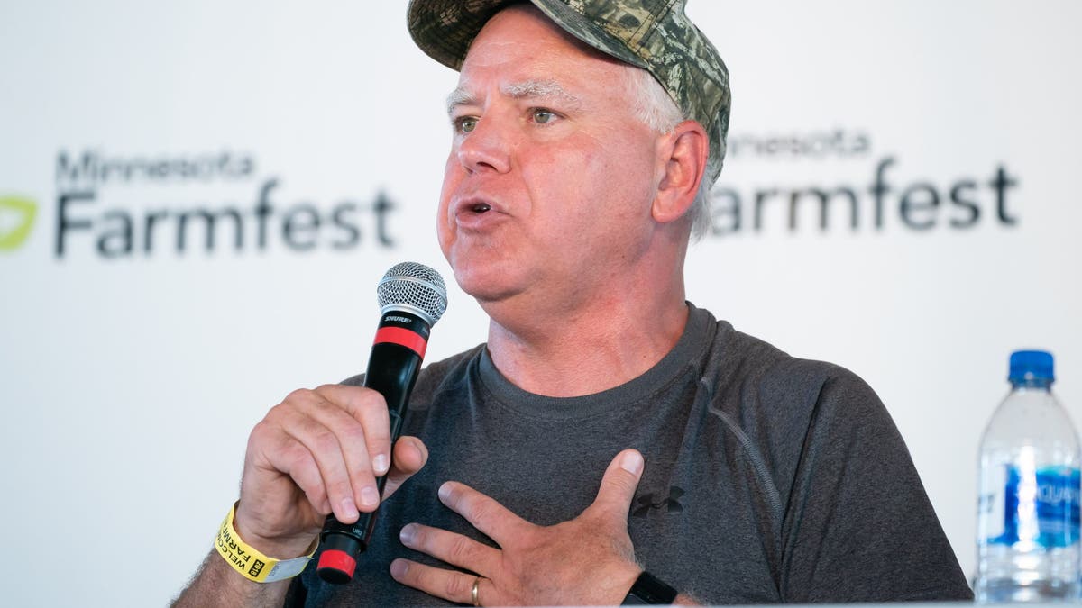 closeup shot of Gov. Tim Walz holding microphone