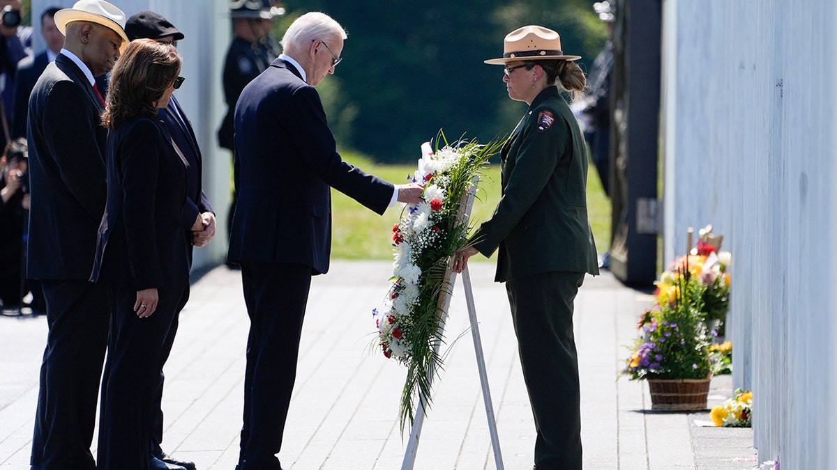 President Joe Biden places a wreath