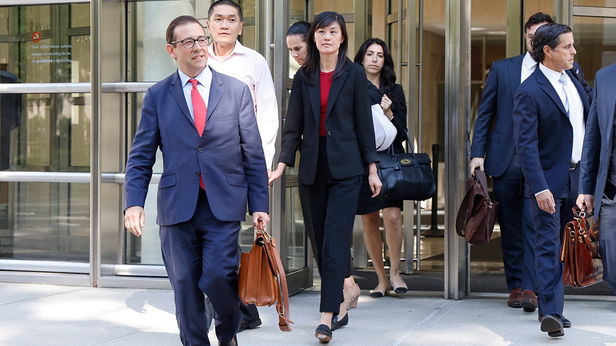 Linda Sun and husband leave court