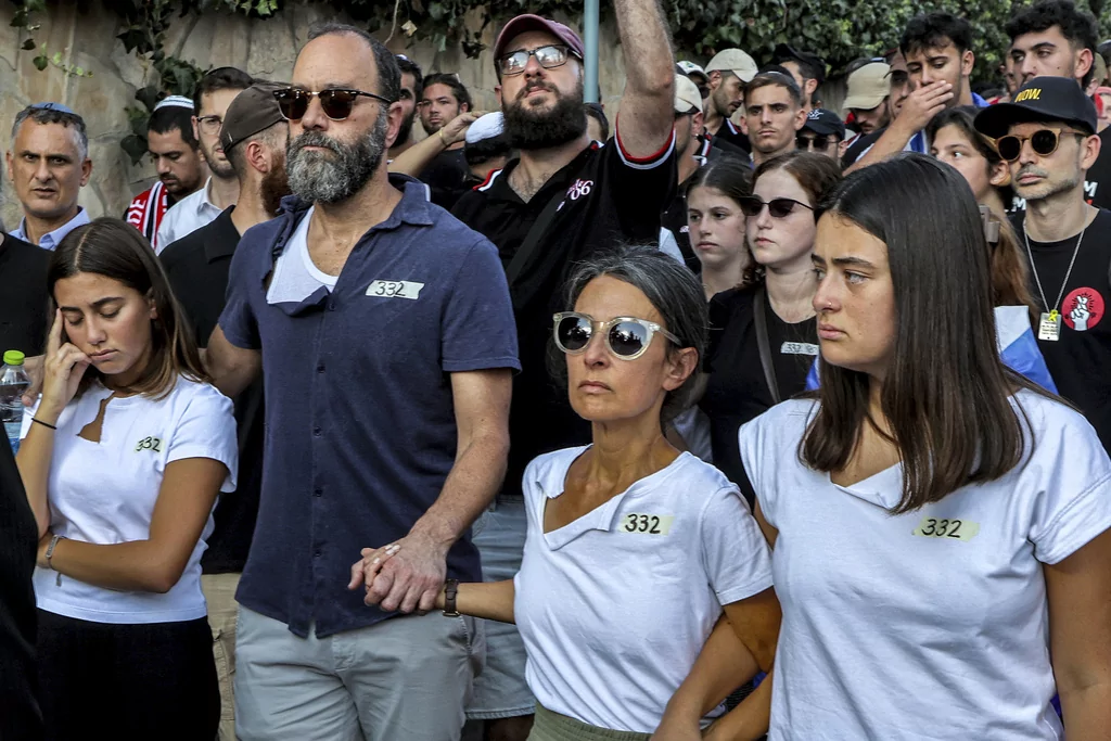 Jonathan Polin, center left, and Rachel Goldberg, center right, parents of Israeli-American hostage Hersh Goldberg-Polin, who was killed in Hamas captivity in the Gaza Strip, attend their son's funeral in Jerusalem, Monday, Sept. 2, 2024. (Gil Cohen-Magen/Pool via AP)