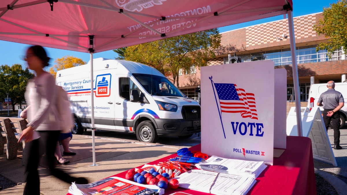 A person walks past Montgomery Countys voter services van in King of Prussia, Pa., Tuesday, Oct. 22, 2024. (AP Photo/Matt Rourke)