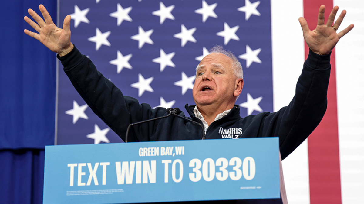 Tim Walz with his arms up