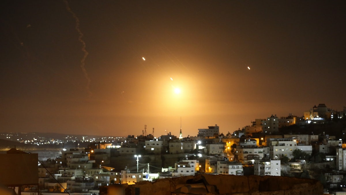 Many rockets, fired from Iran, are seen over Jerusalem from Hebron, West Bank, on Oct. 1, 2024.