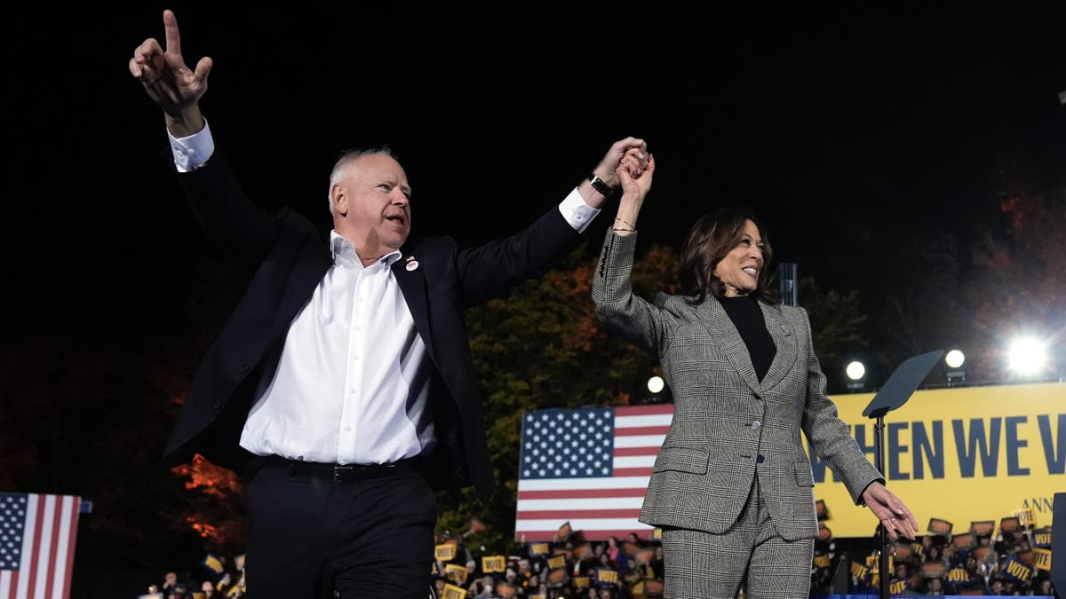 Democratic presidential nominee Vice President Kamala Harris, right, and her running mate Minnesota Gov. Tim Walz depart after speaking during a campaign rally at Burns Park in Ann Arbor, Mich., Monday, Oct. 28, 2024. (AP Photo/Paul Sancya)