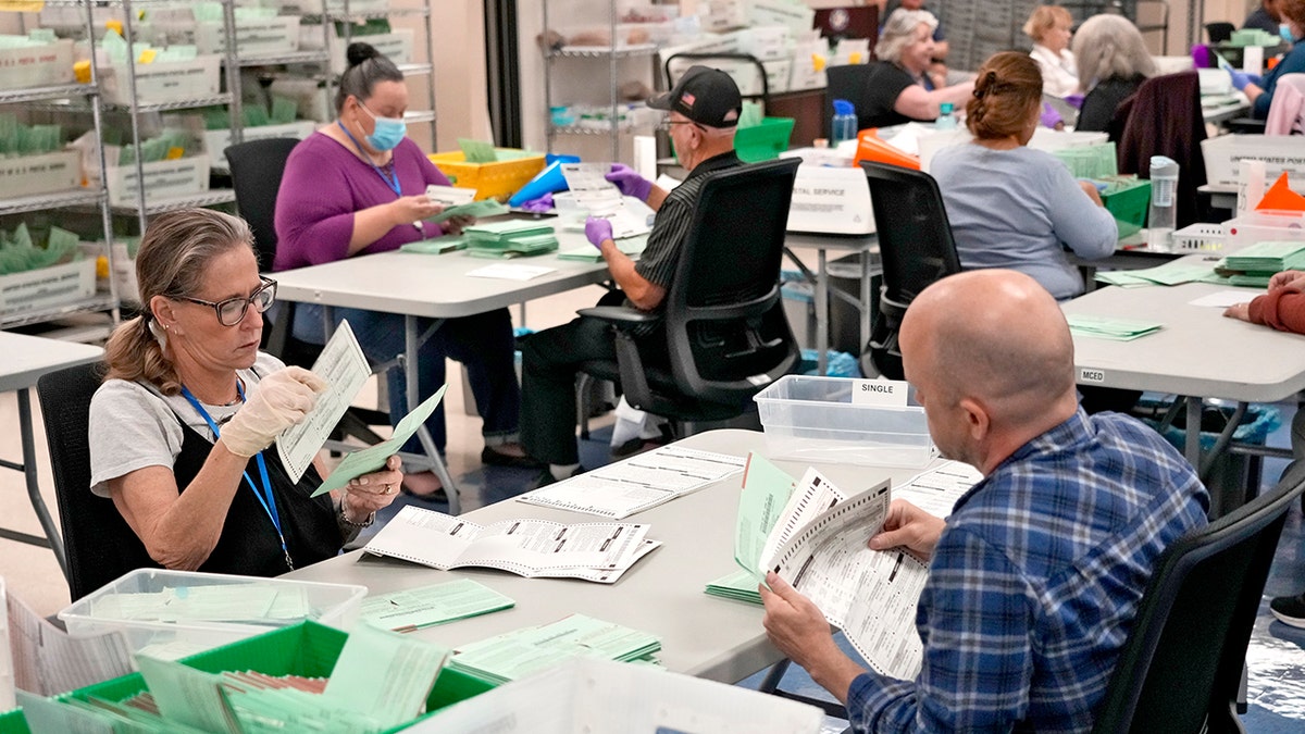 Ballots are counted at the Maricopa County Recorder's Office in Phoenix on Oct. 23.