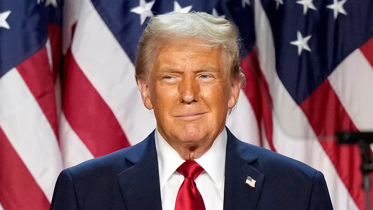 Trump closeup shot with US flags behind him