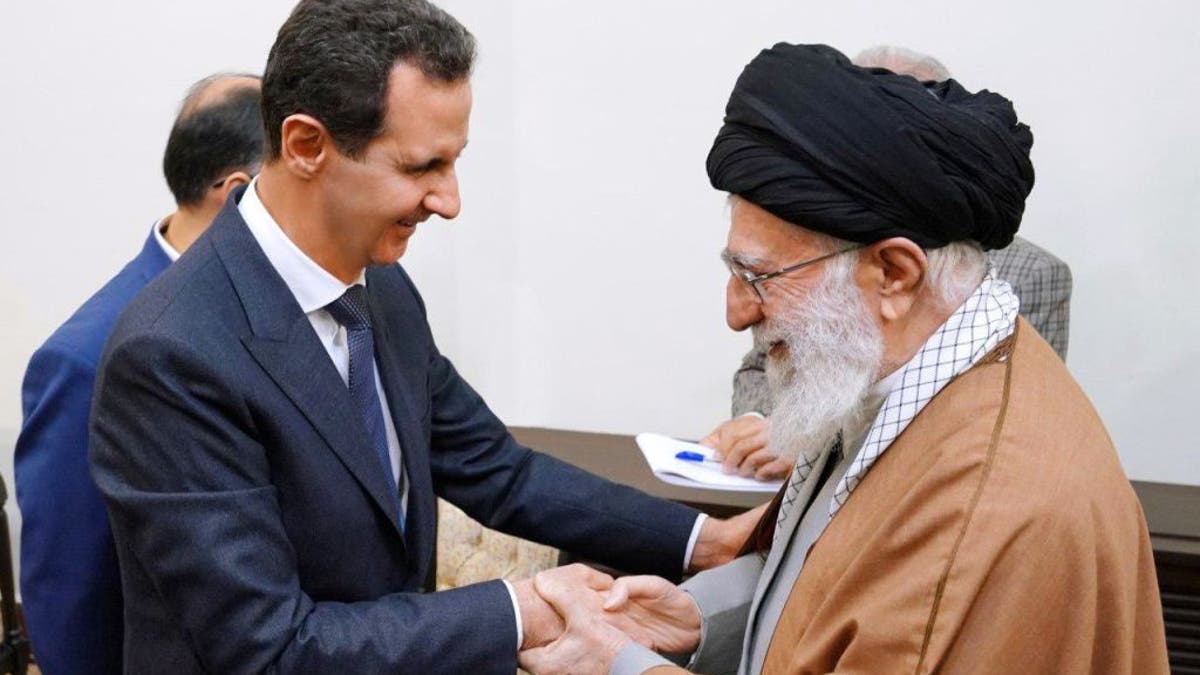 The ayatollah, right, with Bashar al-Assad, left