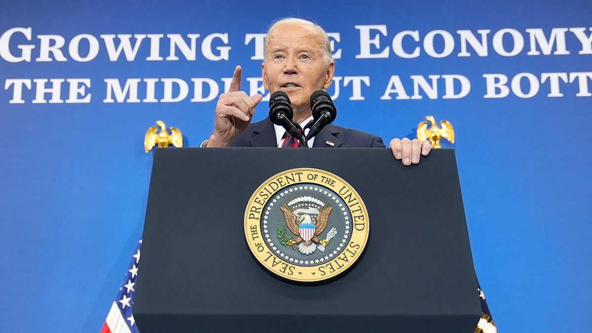 Joe Biden at lectern pointing