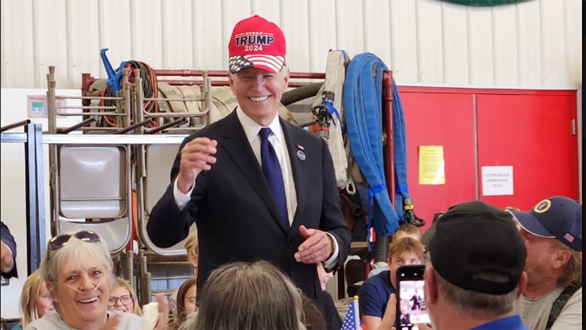 Biden wearing a Trump hat