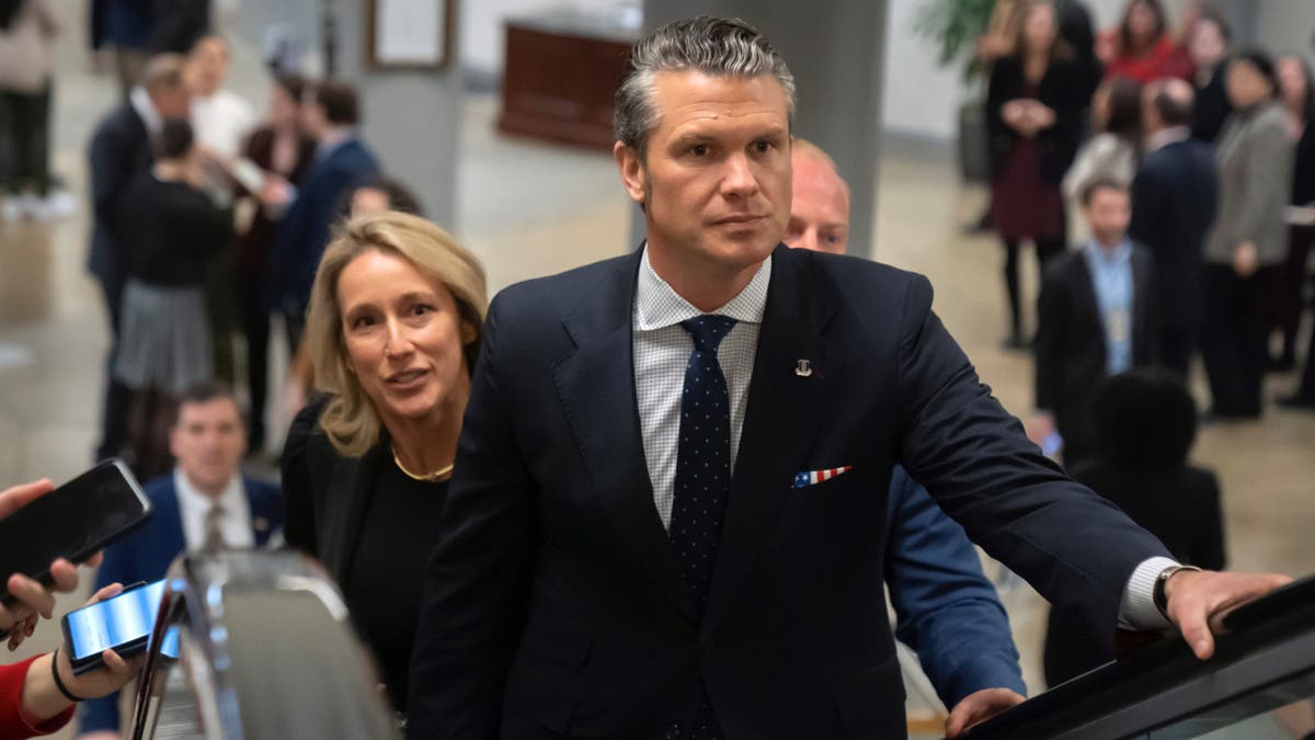 Pete Hegseth, President-elect Donald Trump's nominee to be defense secretary, is joined by his wife Jennifer Rauchet, as they walk through the basement of the Capitol, Wednesday, Dec. 4, 2024, in Washington.