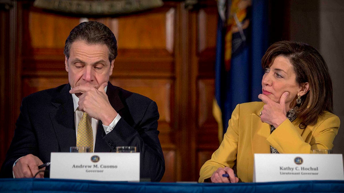 then-Gov. Cuomo, left, with Kathy Hochul, right