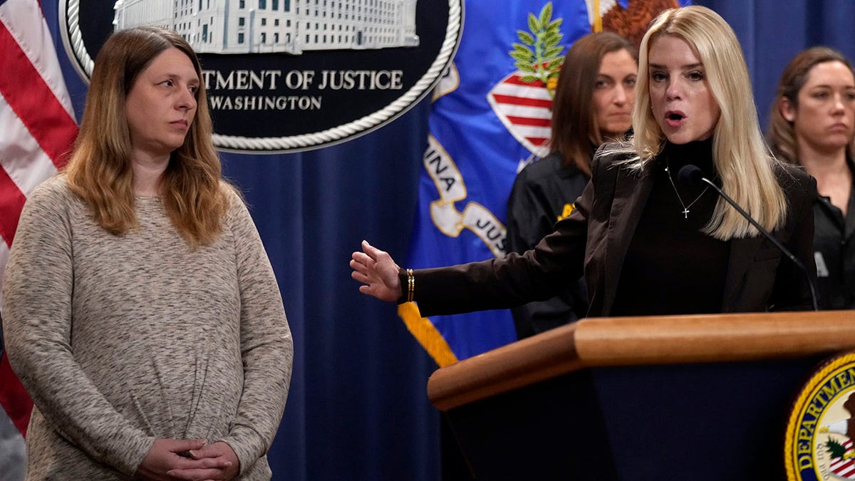 Attorney General Pam Bondi stands next to Tammy Nobles, mother of Kayla Hamilton, during a news conference.