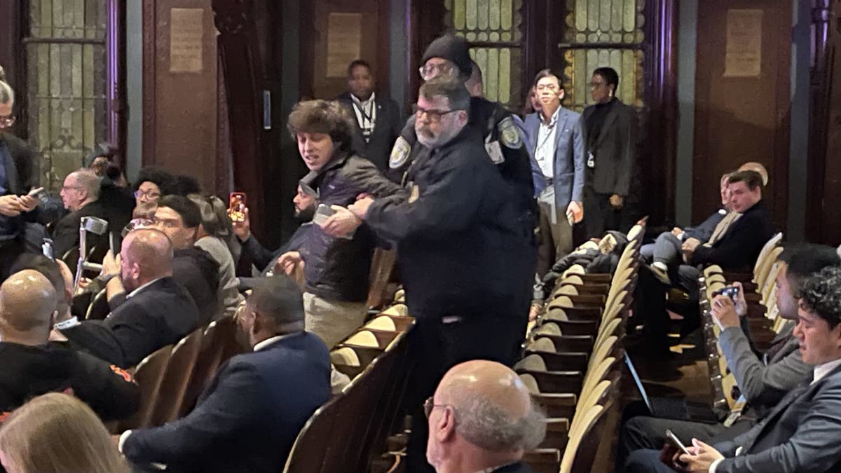 A protester is removed by security after heckling at a Democratic National Committee chair election debate at Georgetown University in Washington, D.C., Jan. 30, 2025