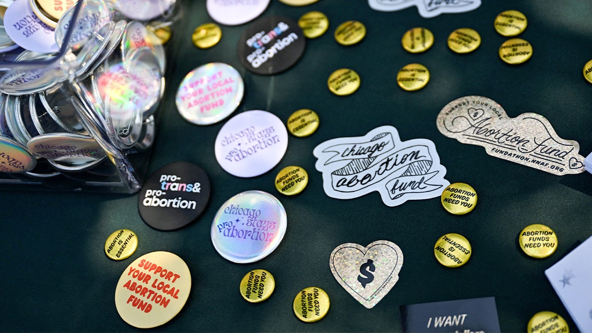 Pins with pro-choice phrases shown outside of a Planned Parenthood mobile clinic