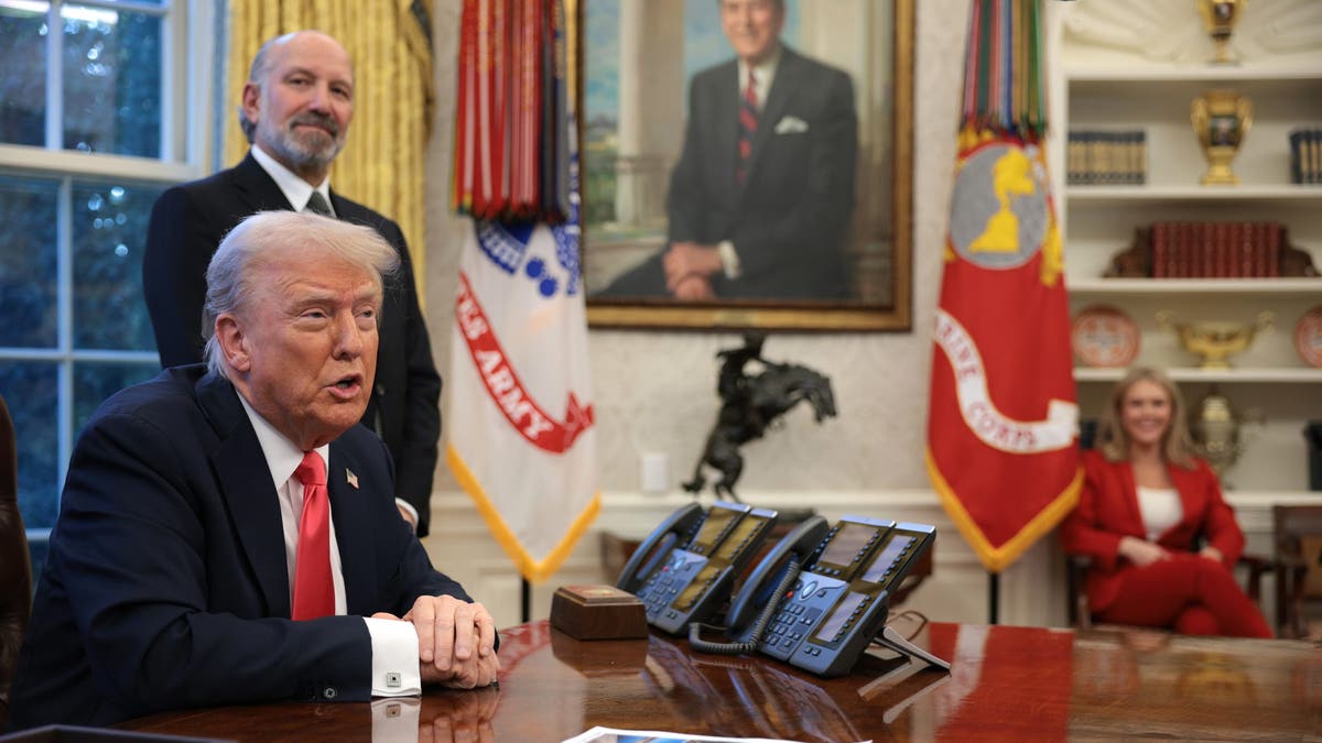 President Donald Trump speaks as Commerce Secretary Howard Lutnick looks on after Trump signed executive orders in the Oval Office on Feb. 25, 2025.