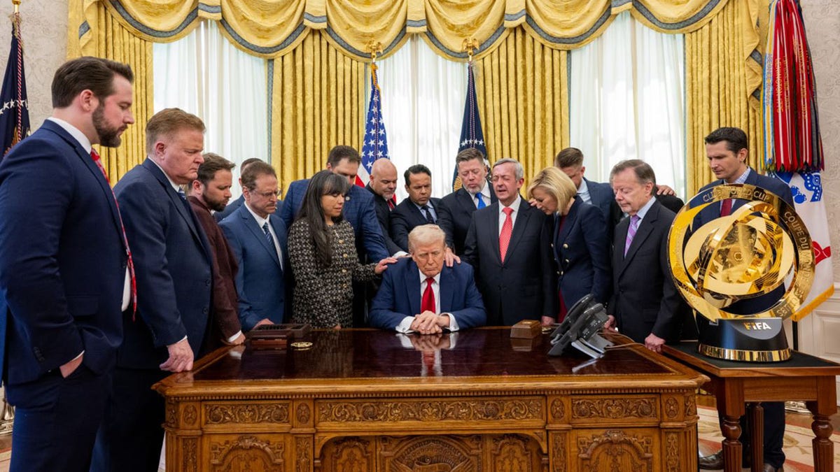 President Donald Trump prays in the White House