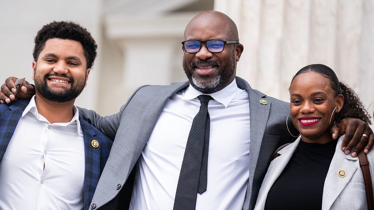 Bowman stands between progressive Democrats Frost and Summer Lee on the House steps