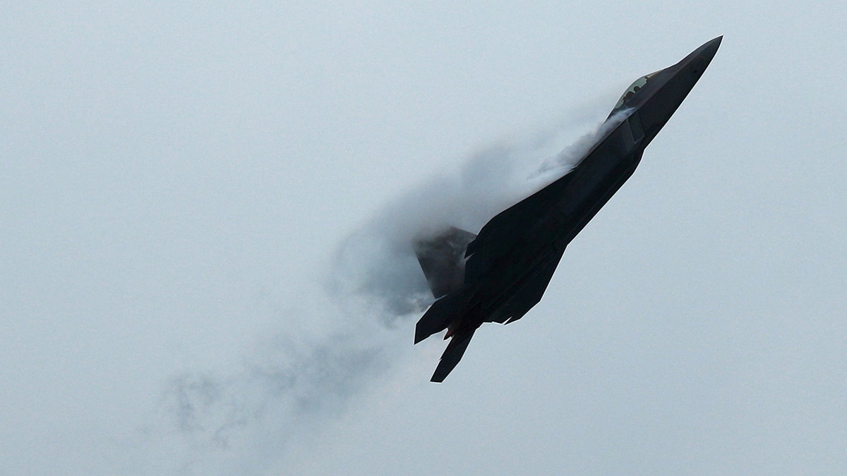 A U.S. Pacific Air Force F-22 Raptor performs an aerial display during a media preview of the Singapore Airshow in Singapore