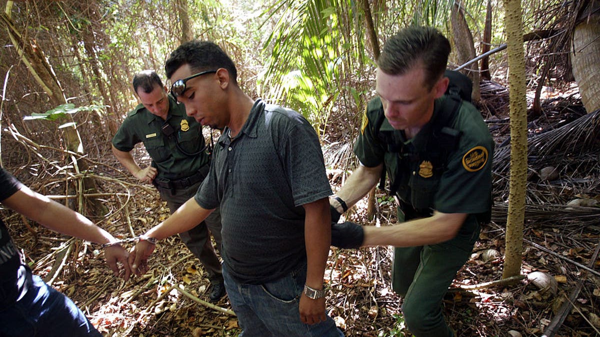 migrant being arrested