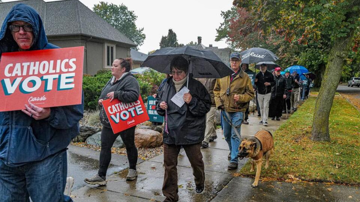 protest march in suburbs with "catholics vote" signs
