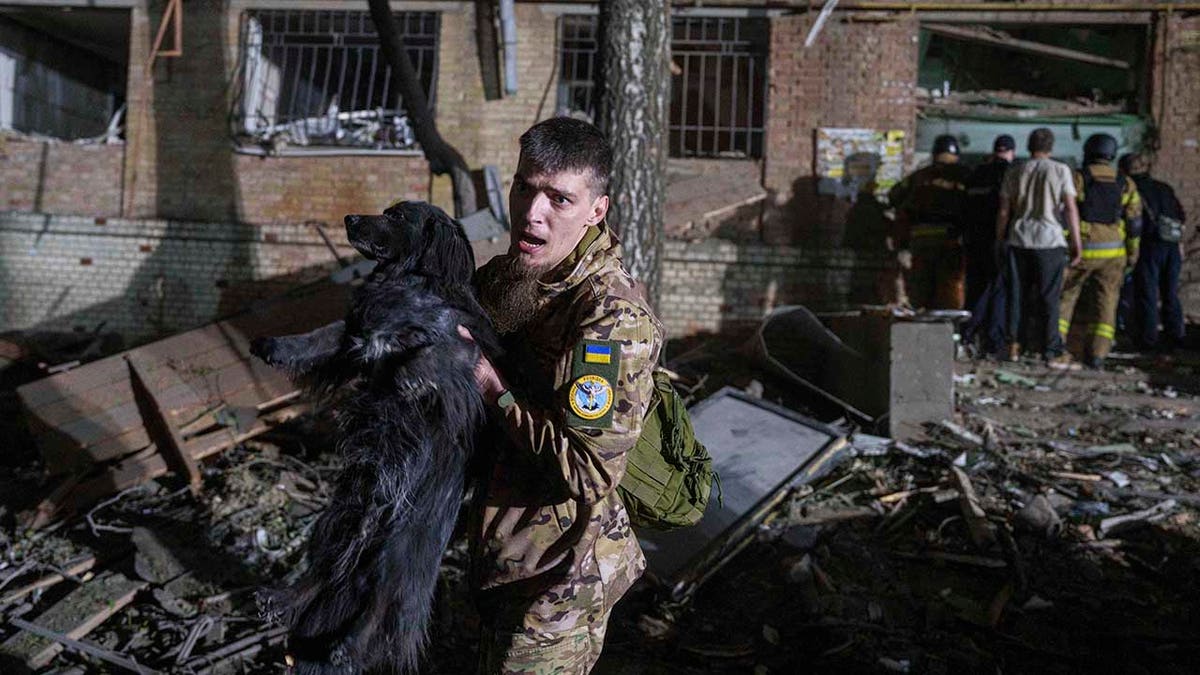 Ukrainian soldier amid rubble