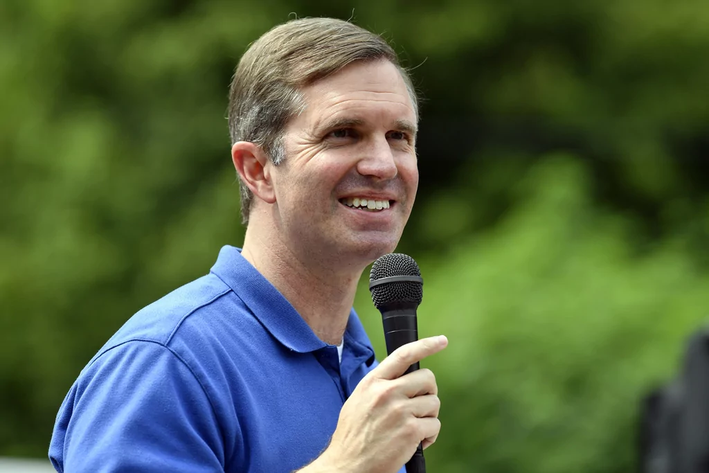 Kentucky Gov. Andy Beshear speaks at the Wayland Volunteer Fire Station in Wayland, Ky., Friday, July 26, 2024. Beshear handed over the keys to newly constructed homes to families that were displaced by the flooding 2 years ago.