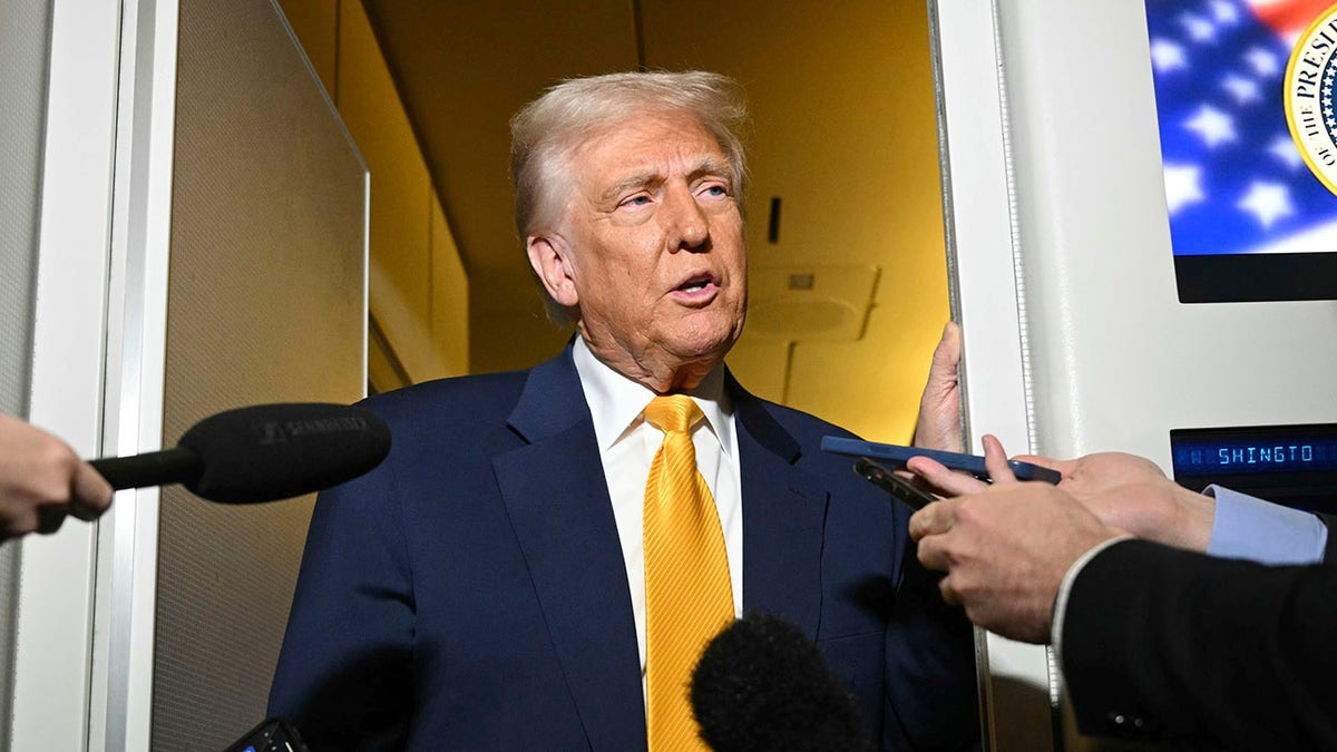 Trump speaks to reporters on Air Force One