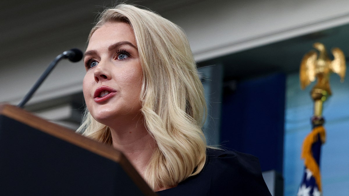 White House Press Secretary Karoline Leavitt speaking into microphone