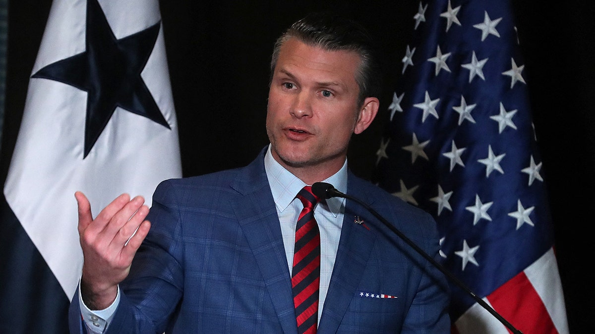 US Secretary of Defense Pete Hegseth speaking at a podium
