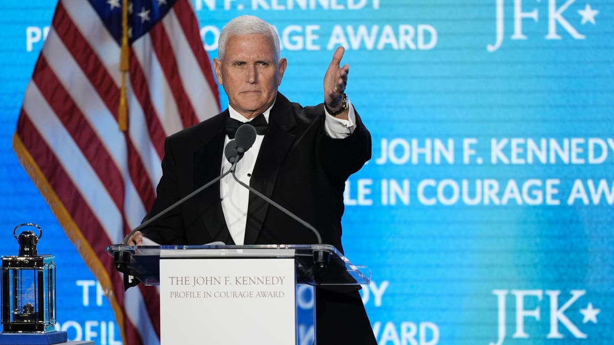 Former Vice President Mike Pence acknowledges his staff members as he speaks after receiving the John F. Kennedy Profile in Courage Award during a ceremony at the JFK Library, Sunday, May 4, 2025, in Boston.