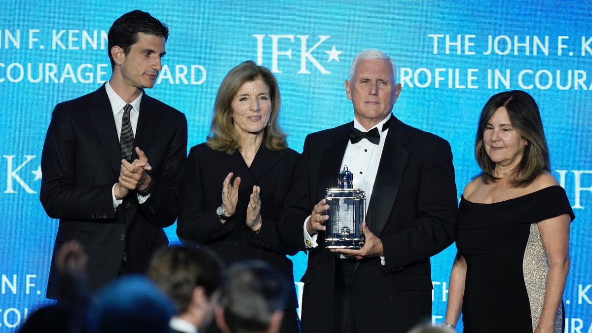 Former Vice President Mike Pence, second from right, stands with his wife, Karen Pence, far right, as he is presented with the John F. Kennedy Profile in Courage Award by Jack Schlossberg and his mother, Caroline Kennedy, at a ceremony at the JFK Library, Sunday, May 4, 2025, in Boston.