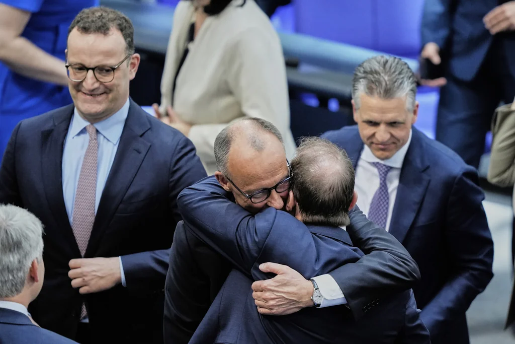 Leader of the Christian Democrats Friedrich Merz hugs Alexander Dobrindt from the CSU after being elected new chancellor at the German federal parliament, Bundestag, at the Reichstag building in Berlin, Germany, Tuesday, May 6, 2025.