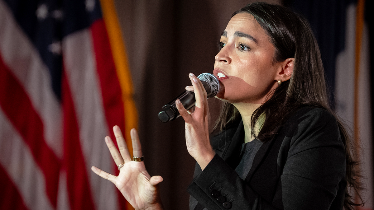 AOC holding microphone, closeup shot