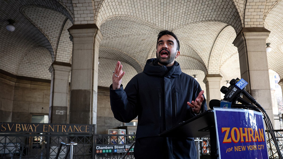 Zohran Mamdani speaking at a podium