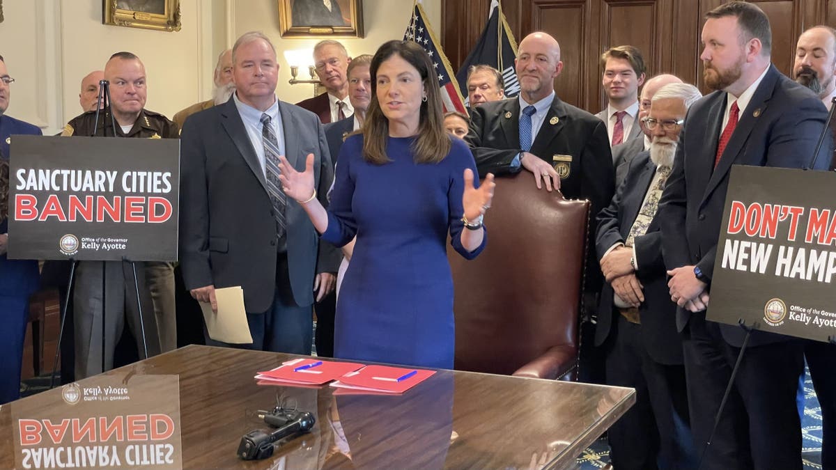Republican Gov. Kelly Ayotte of New Hampshire highlights her state's status as the safest in the nation as she signs into law two bills that ban sanctuary cities, at the Statehouse in Concord, N.H., on Thursday.